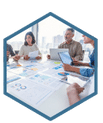 A group of employees in business casual attire, learning project management tools on their laptops during a private workshop. The facilitator stands in front presenting a project schedule template on the screen.