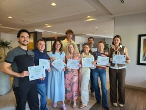 TrainSMART 3-Day Train-the-Trainer workshop participants in Nashville, TN, holding certificates of completion after the June 23–25, 2026 program.